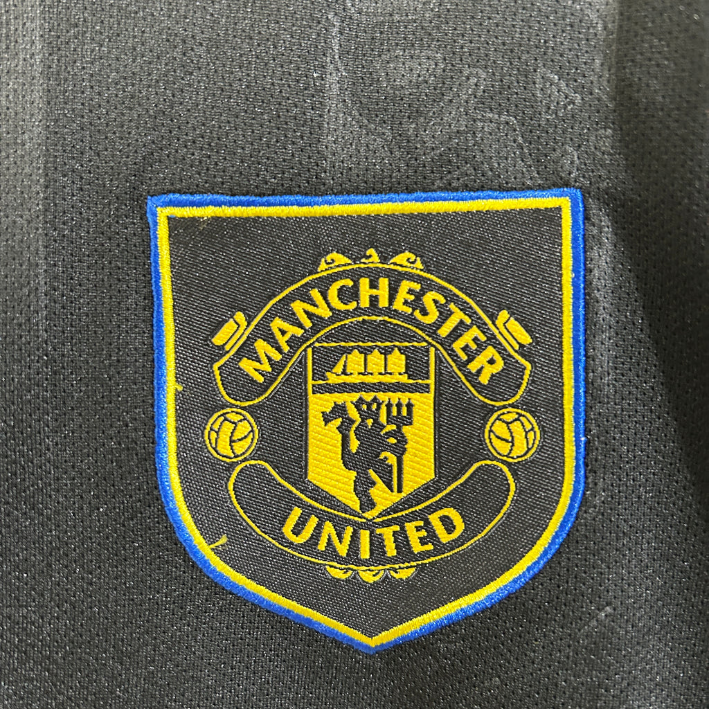 Kit Criança Alternativo Preto Manchester United 2025/2026